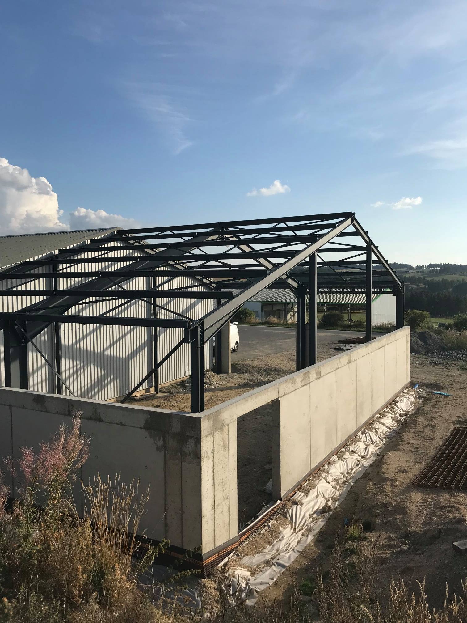 Steel frame of a commercial building being erected on a concrete base